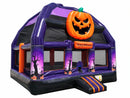 Haunted Castle Bongo Bounce House from the front right, carved pumpkin above the striped entry step