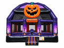 Haunted Castle Bongo Bounce House front view with a carved pumpkin and a Happy Halloween banner over the door
